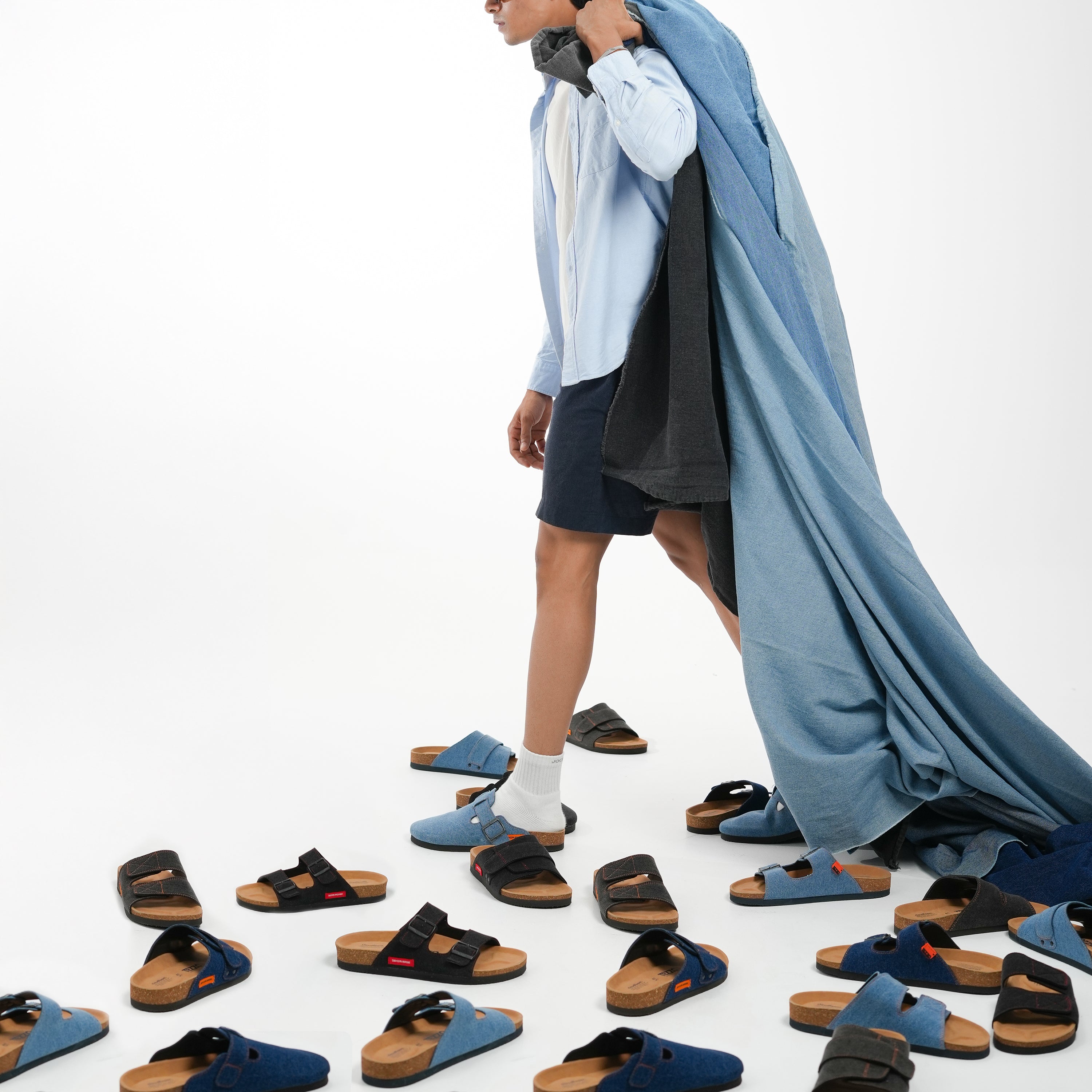 Person wearing a blue garment with sandals displayed on a white background